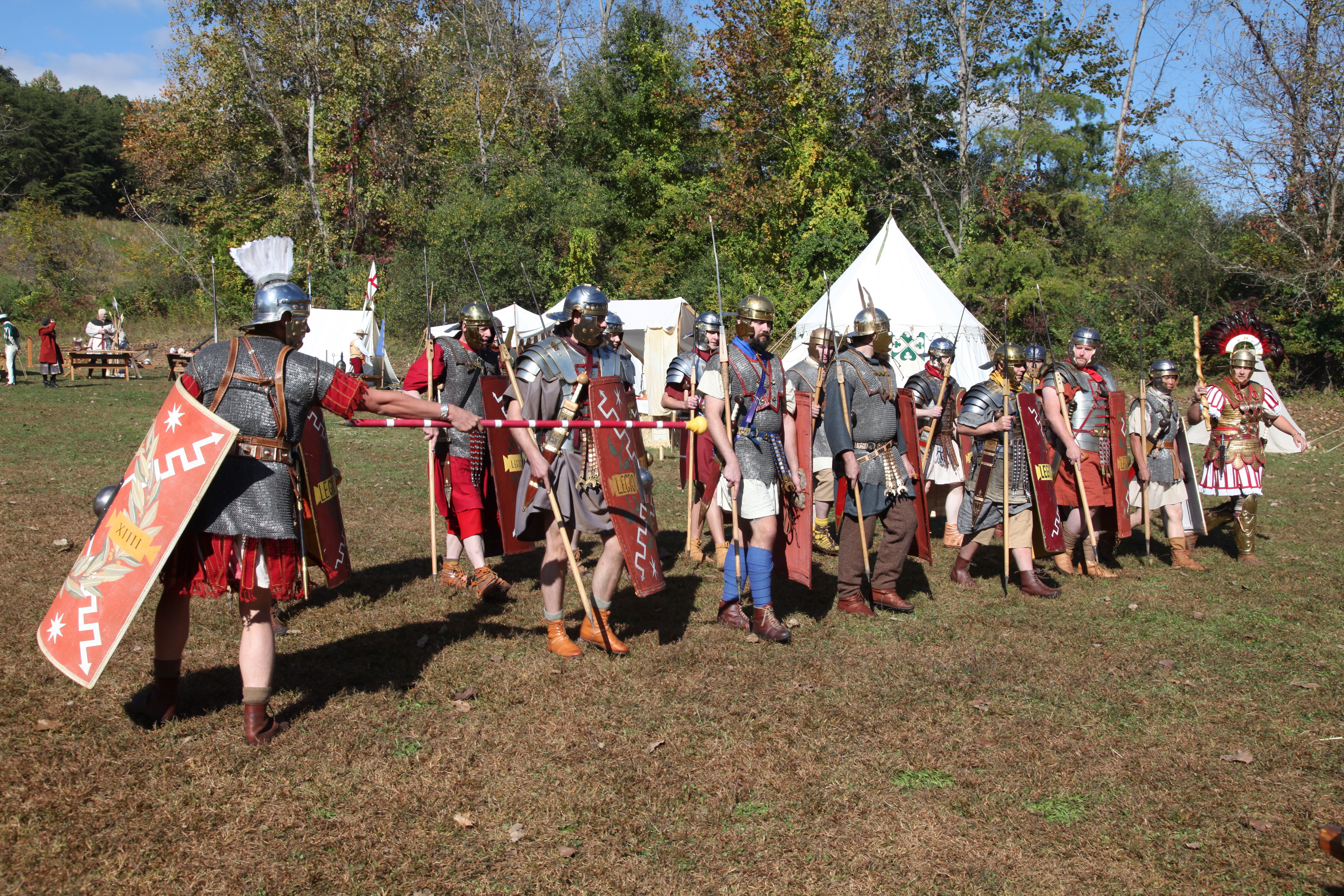 Living history enthusiasts reenact a Roman legion amassed for battle.